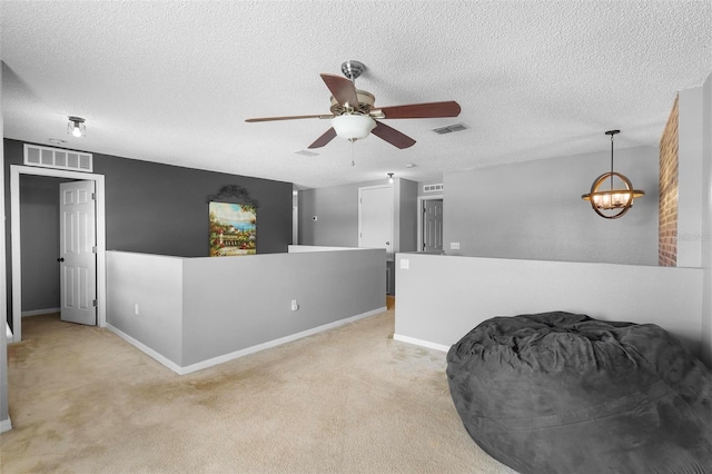 interior space with ceiling fan with notable chandelier and a textured ceiling