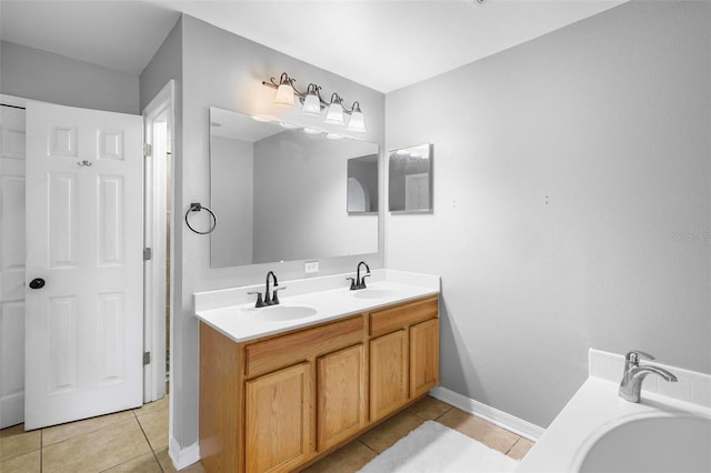 bathroom with vanity, a bath, and tile patterned floors