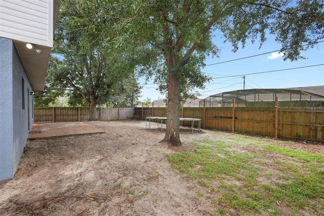 view of yard with a patio area and a trampoline