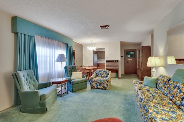 carpeted living area with a notable chandelier, visible vents, and a textured ceiling