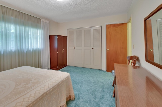 carpeted bedroom with a closet and a textured ceiling