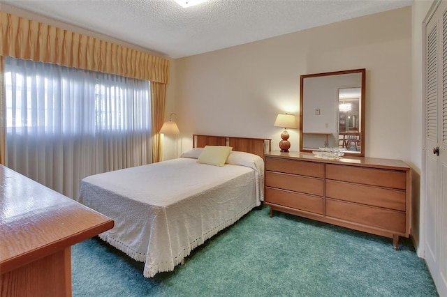 carpeted bedroom featuring a closet and a textured ceiling