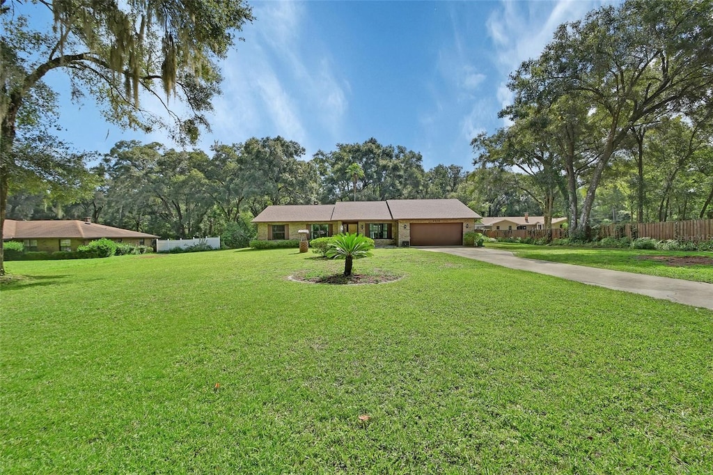 view of front facade featuring a front lawn and a garage