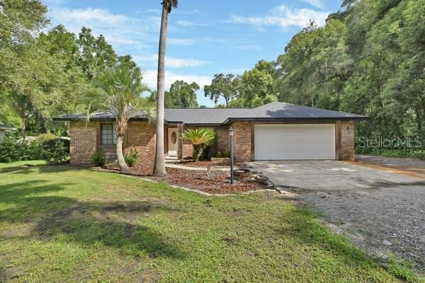 single story home with a garage and a front yard