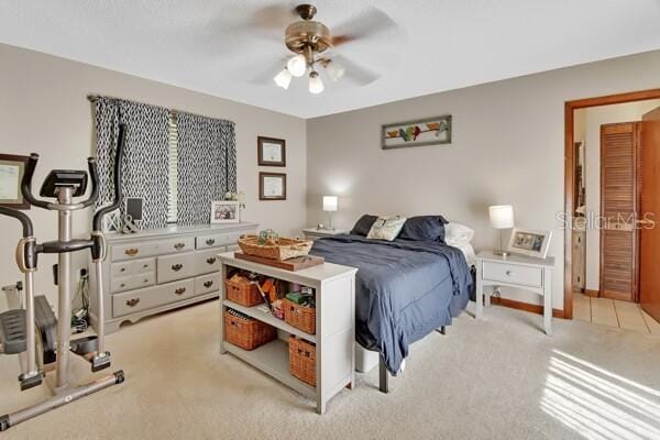 bedroom with light colored carpet and ceiling fan