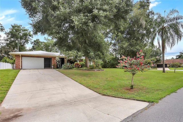 view of front of home with a garage and a front lawn