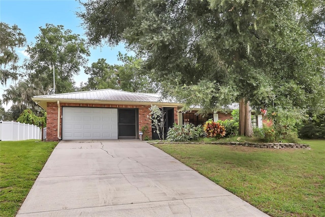 ranch-style home with a garage and a front lawn