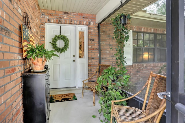 view of exterior entry with a porch