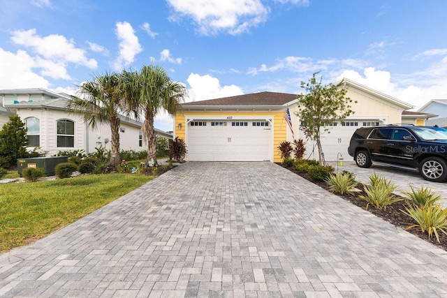 view of front of house with a garage and a front yard