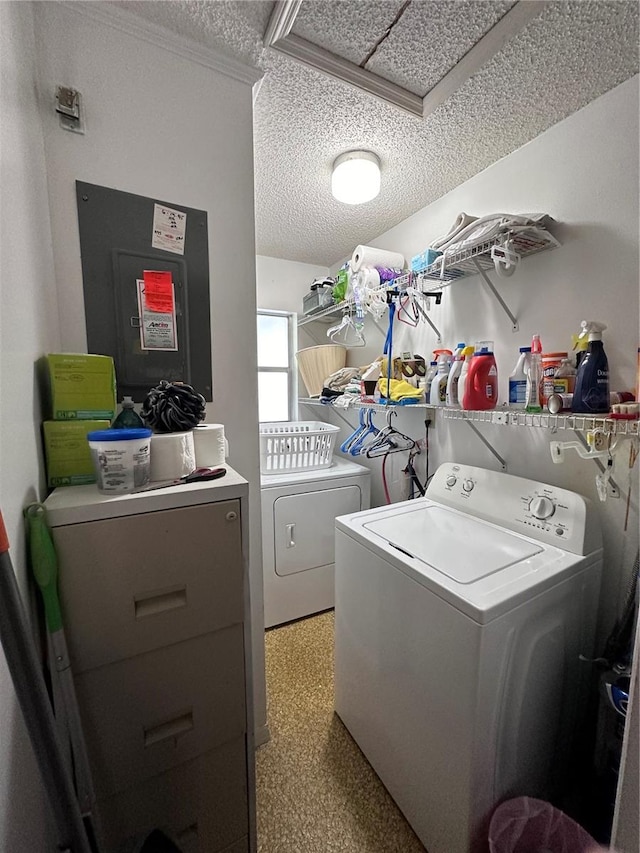 clothes washing area with electric panel, separate washer and dryer, and a textured ceiling