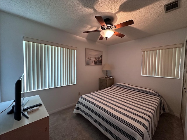 bedroom featuring a textured ceiling, ceiling fan, and carpet floors