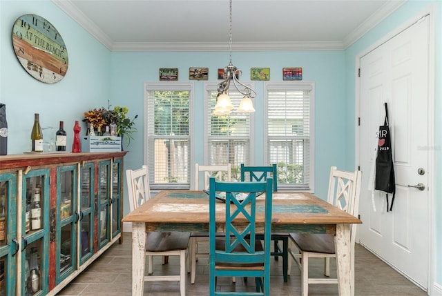 dining space featuring a notable chandelier, a wealth of natural light, and crown molding