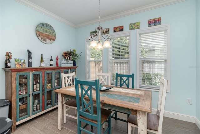 dining area with a notable chandelier, crown molding, and hardwood / wood-style floors