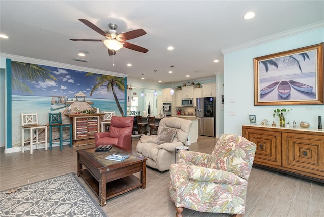 living room featuring light hardwood / wood-style floors, ornamental molding, and ceiling fan