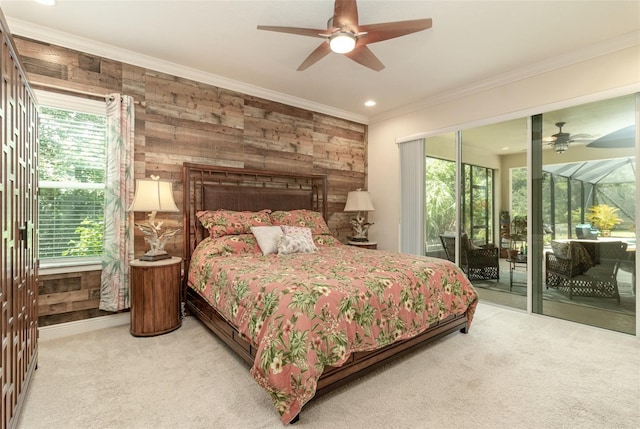 bedroom featuring ceiling fan, access to outside, wood walls, carpet, and crown molding