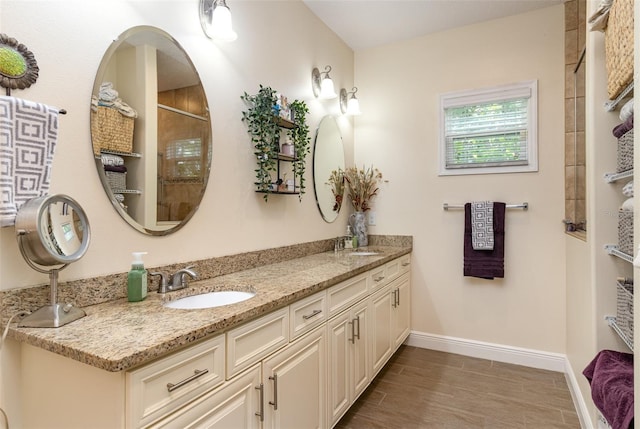 bathroom featuring walk in shower, vanity, and hardwood / wood-style floors