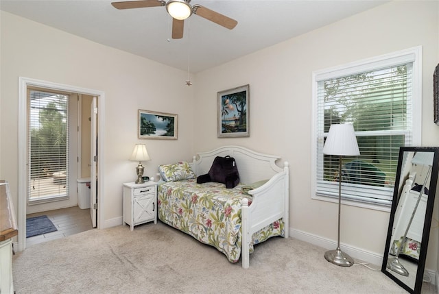 carpeted bedroom with multiple windows and ceiling fan