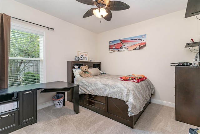 bedroom featuring light carpet and ceiling fan