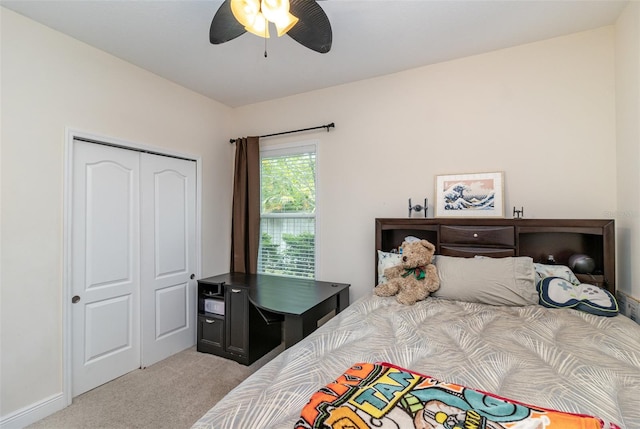 carpeted bedroom with a closet and ceiling fan