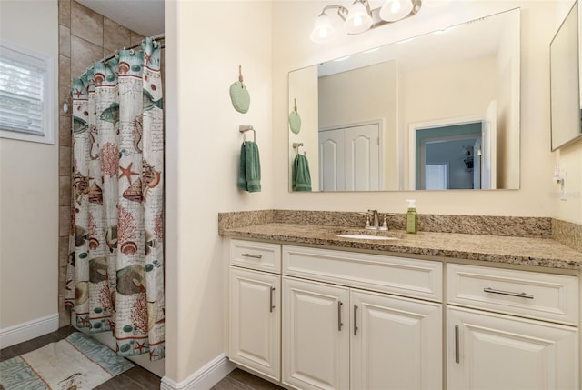 bathroom with hardwood / wood-style flooring, walk in shower, and vanity