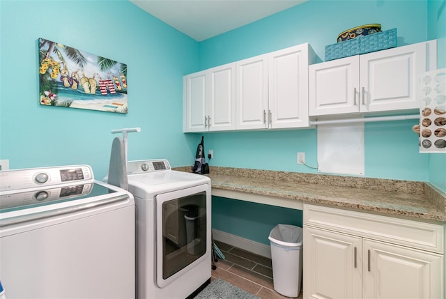 washroom featuring cabinets and washing machine and dryer