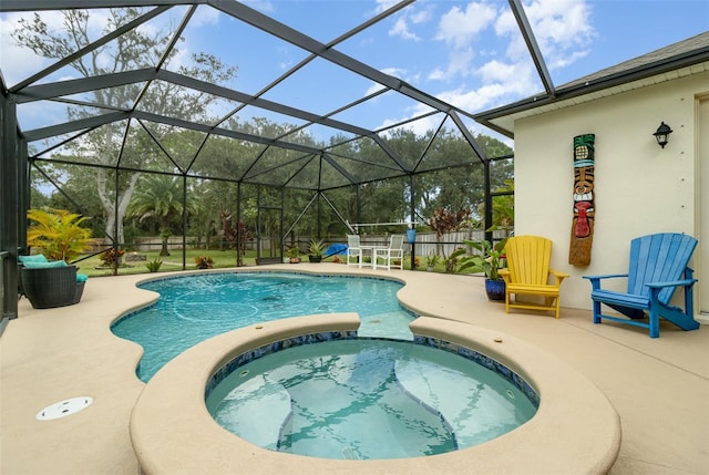 view of swimming pool featuring an in ground hot tub, a lanai, and a patio area