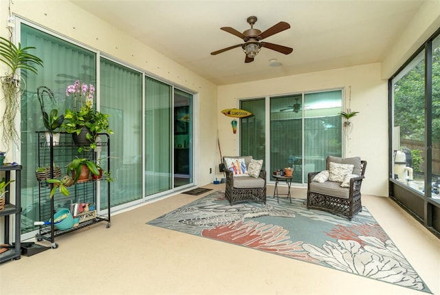 sunroom / solarium featuring a wealth of natural light and ceiling fan