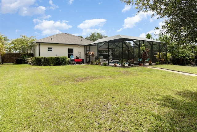 exterior space with a yard, a swimming pool, and glass enclosure