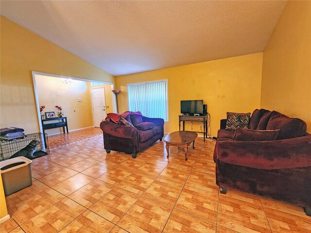 living room with a textured ceiling and vaulted ceiling