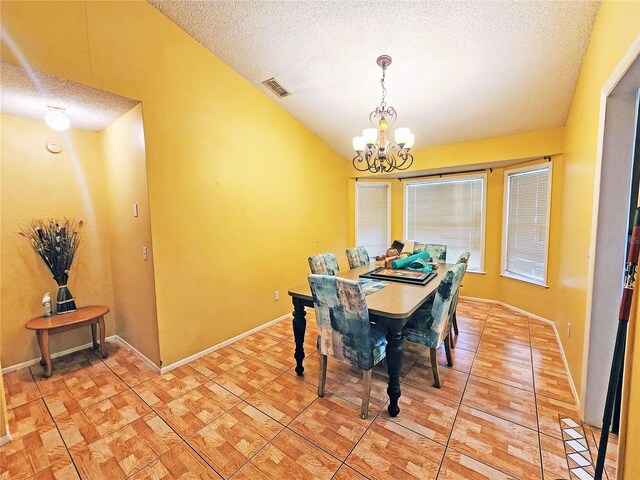 dining room with lofted ceiling, a notable chandelier, and a textured ceiling