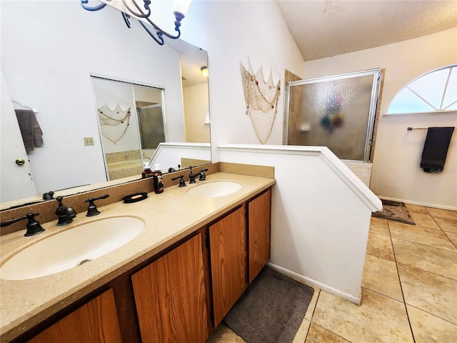 bathroom featuring tile patterned flooring, vanity, a textured ceiling, a chandelier, and a shower with shower door