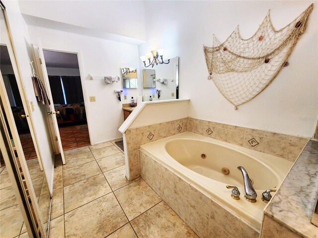 bathroom featuring tile patterned floors, tiled tub, and vanity