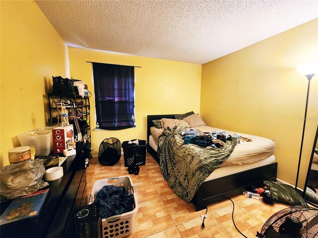 bedroom featuring light hardwood / wood-style flooring and a textured ceiling