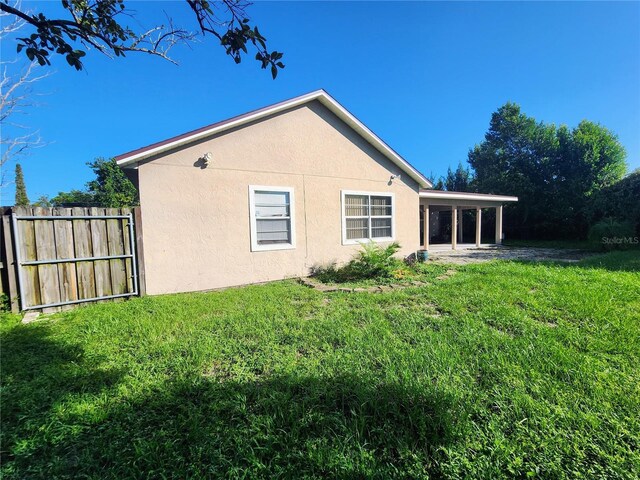 back of property featuring a yard