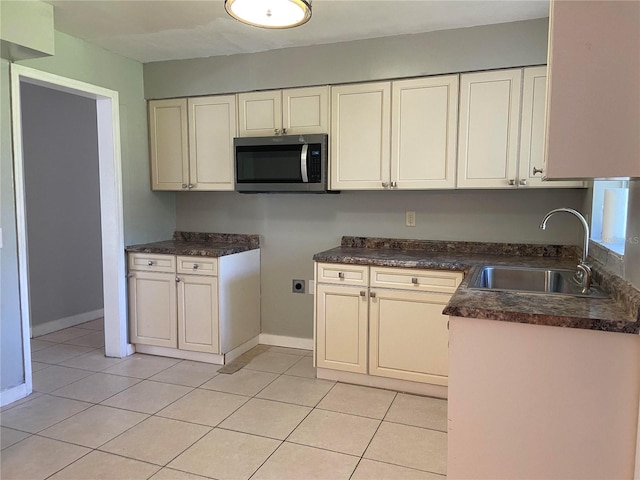 kitchen with light tile patterned floors and sink