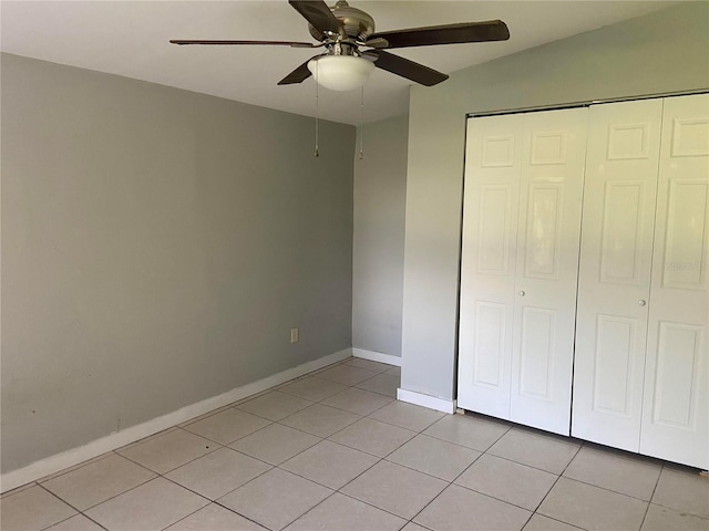 unfurnished bedroom featuring light tile patterned floors, ceiling fan, and a closet