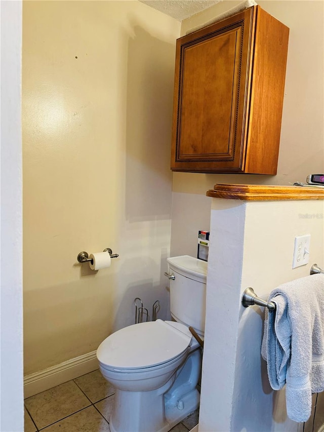 bathroom featuring toilet and tile patterned floors