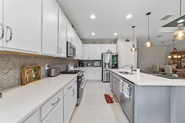 kitchen with backsplash, stainless steel appliances, and white cabinets