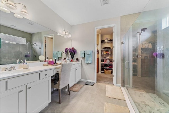 bathroom featuring vanity, an enclosed shower, and tile patterned floors