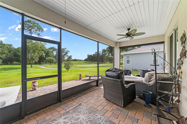 sunroom featuring a wealth of natural light and ceiling fan