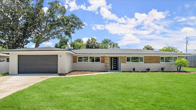 ranch-style home featuring a garage and a front lawn