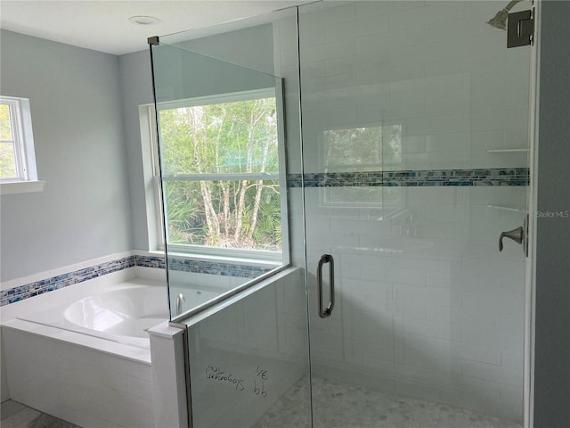 bathroom with shower with separate bathtub