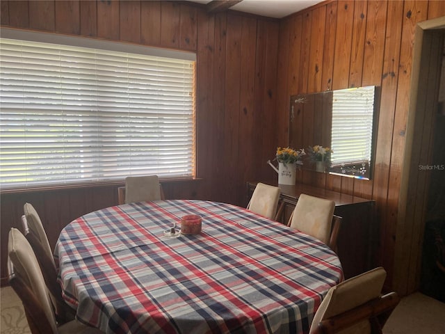 dining room featuring wooden walls