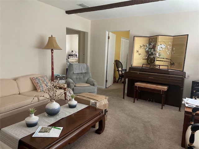 carpeted living room with beamed ceiling and visible vents