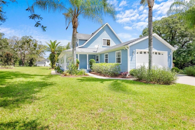 view of front of home with a garage, a front yard, and a porch