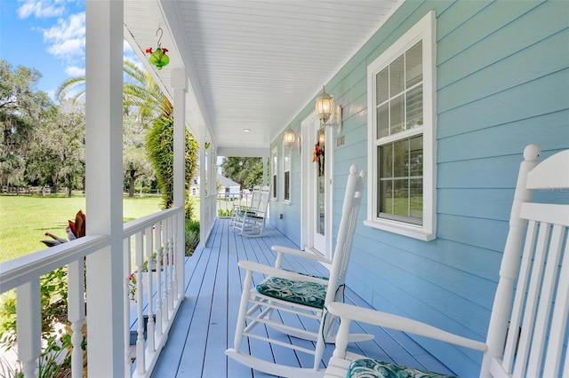 deck featuring a porch and a lawn