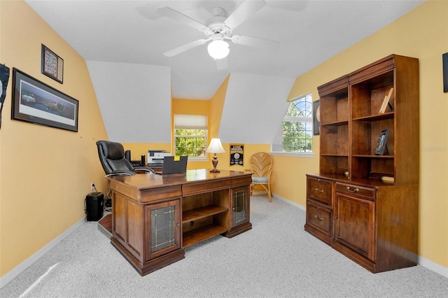 carpeted office space with lofted ceiling and ceiling fan