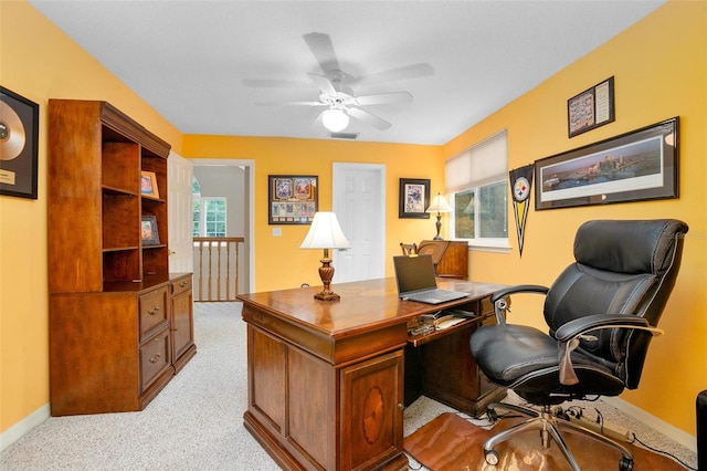 office area featuring ceiling fan and light carpet