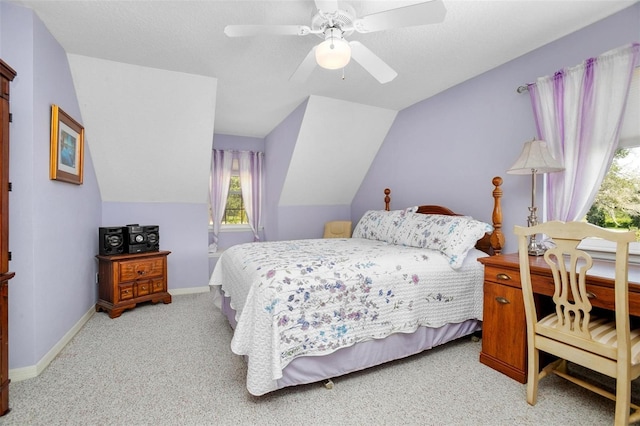 bedroom featuring lofted ceiling, ceiling fan, light carpet, and a textured ceiling