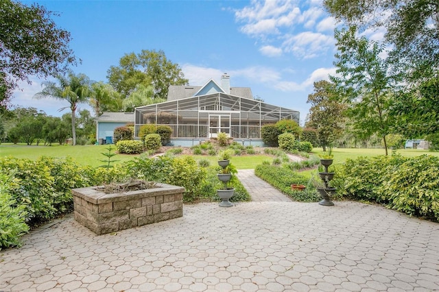 view of property's community with a patio area and a lawn